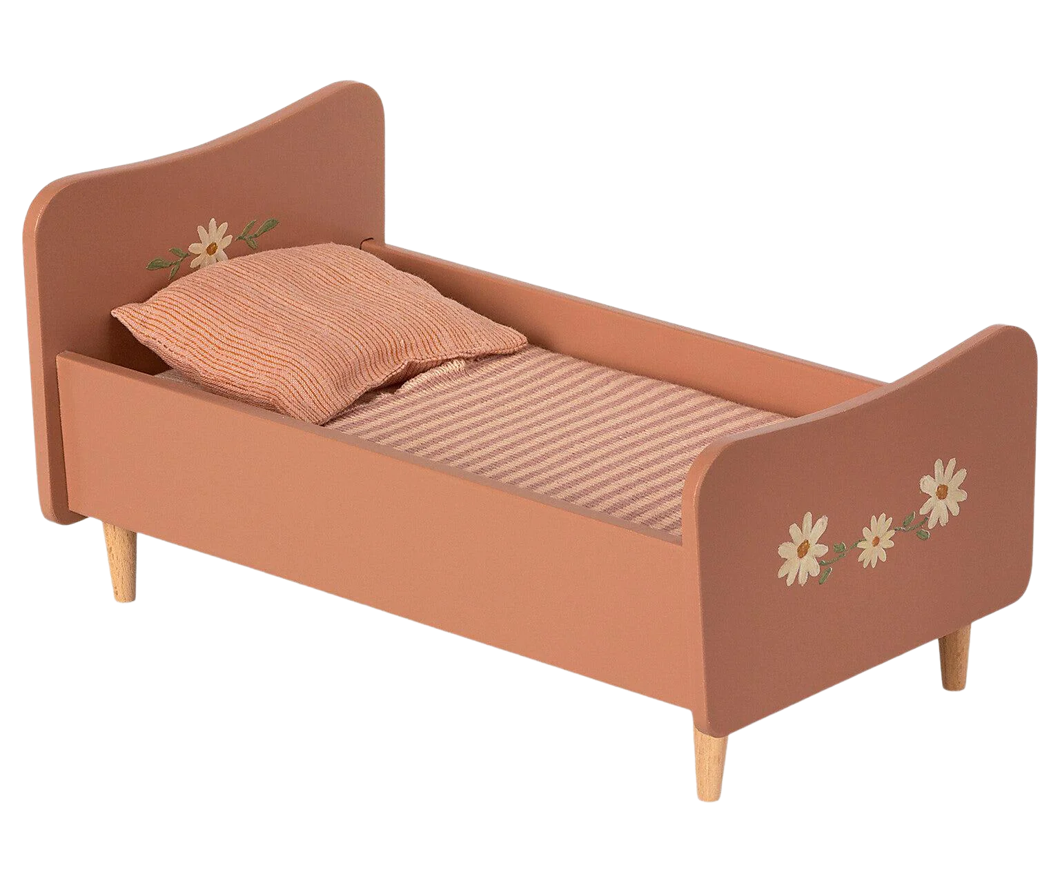 A small, Maileg Wooden Bed, Mini painted in a muted orange color featuring floral decorations and handpainted details of bunnies and rabbits on the headboard and footboard. The bed is furnished with a striped mattress and an orange pillow, supported by four short wooden legs.